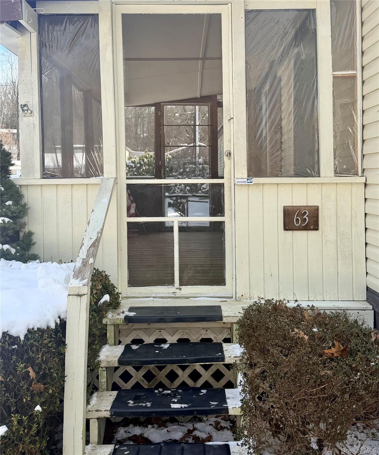 63 Tanglewood Road Hopewell Junction, NY 12533 - Photo 2 of 25 a room with a black white checkered floor and a large window