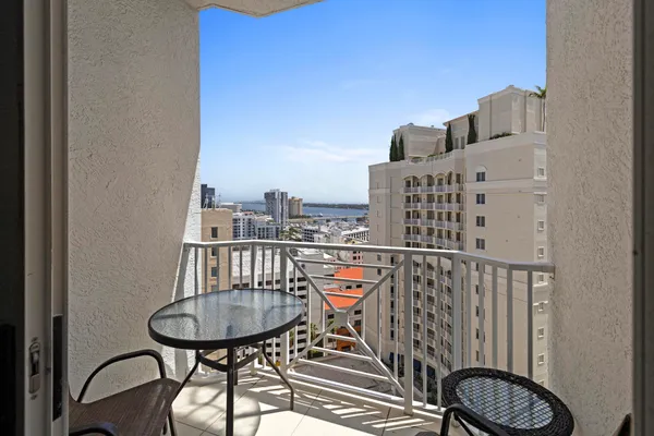 a balcony with a table and chairs
