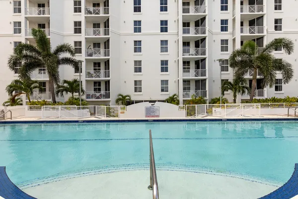 a building view with swimming pool and outdoor seating