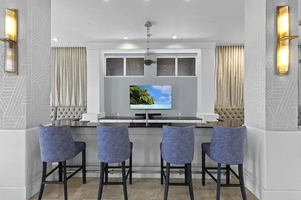 a room with pool table and windows