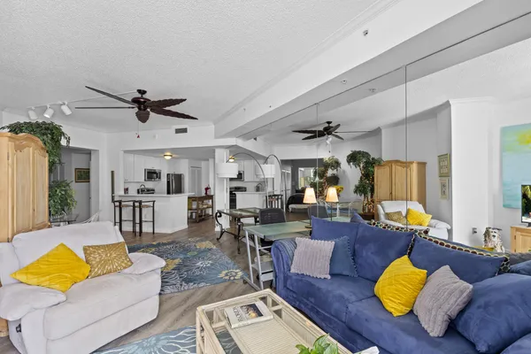 a living room filled with furniture wooden floor and a table