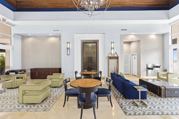 a living room with furniture and a floor to ceiling window