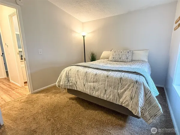 a bed sitting in a bedroom next to a window