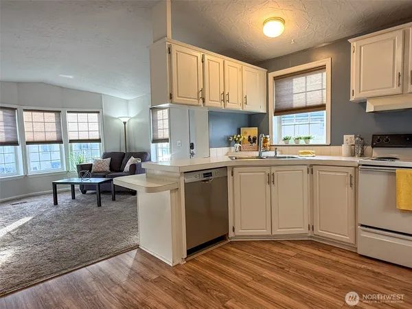 a kitchen with a sink cabinets and window