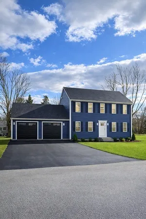 front view of a brick house next to a yard
