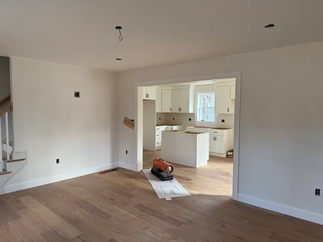 a kitchen view with white cabinets and sink