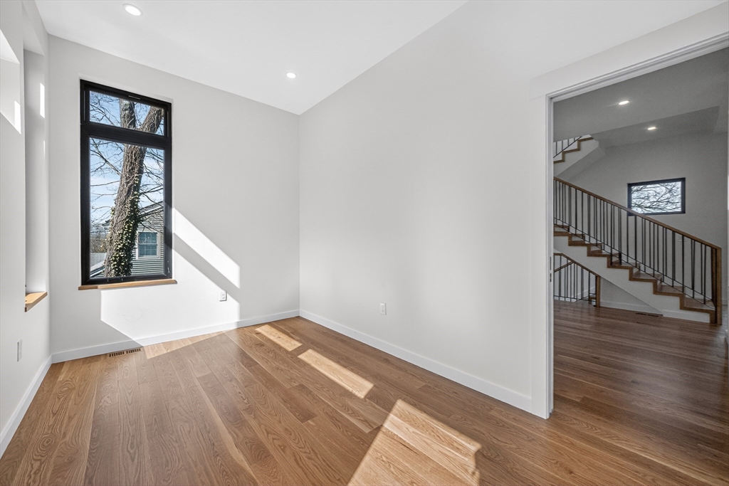 15 Bird Hill Road Lexington, MA 02421 - Photo 13 of 34 a view of hallway with window and wooden floor