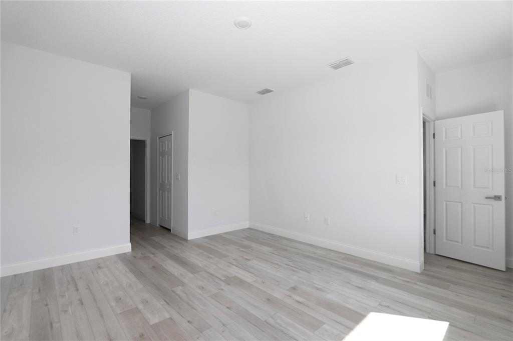 15227 Southwest 28th Avenue Road Ocala, FL 34473 - Photo 8 of 38 a view of an empty room with wooden floor