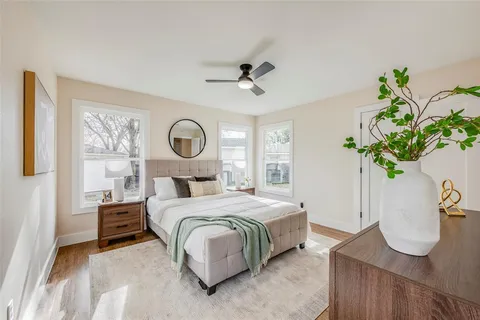 a bedroom with a bed potted plant and a window