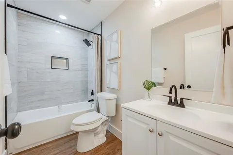 a bathroom with a sink a toilet and a mirror