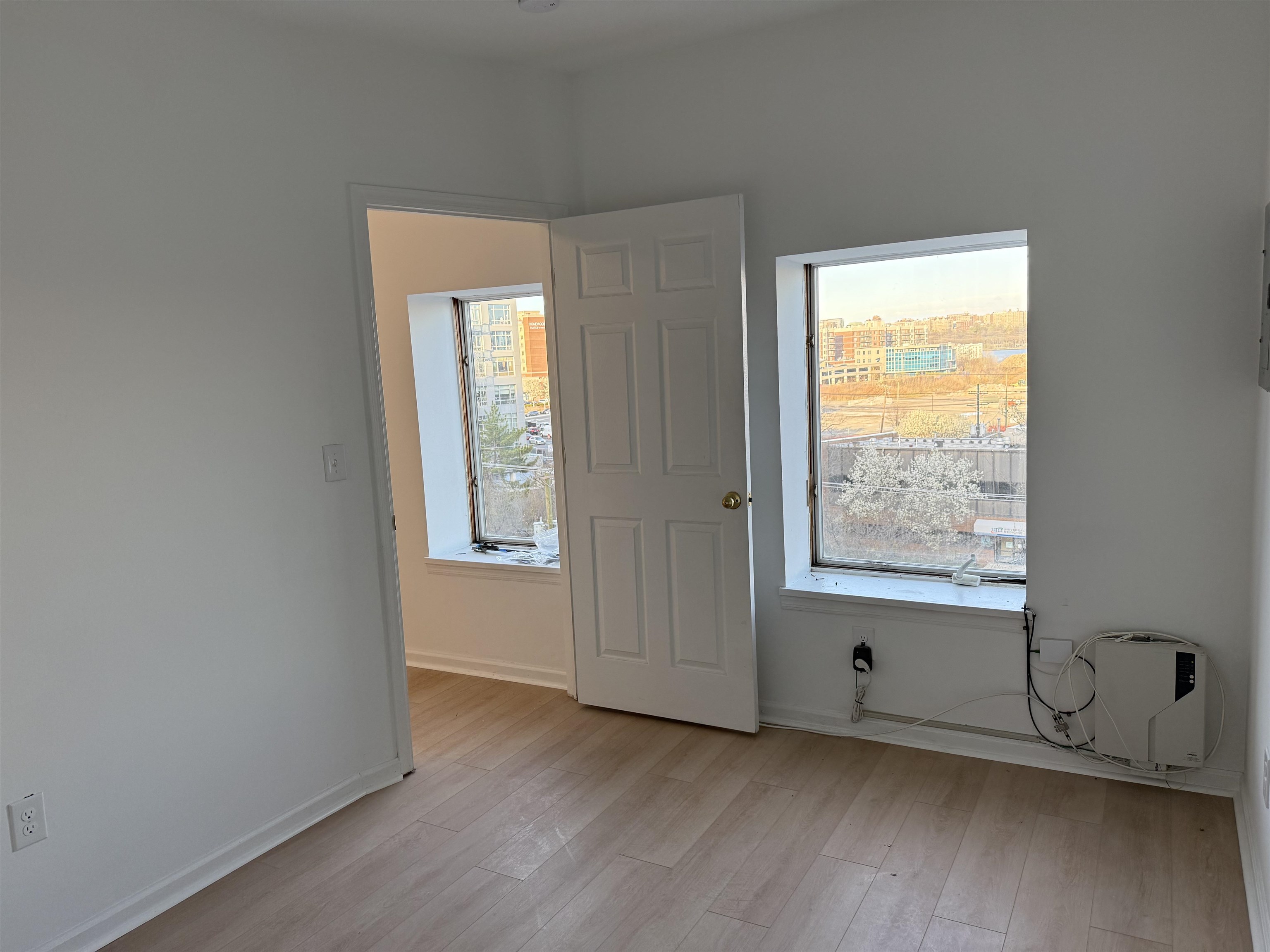 9007 Riverside Place, Unit 3 North Bergen, NJ 07047 - Photo 11 of 18 an empty room with wooden floor and windows