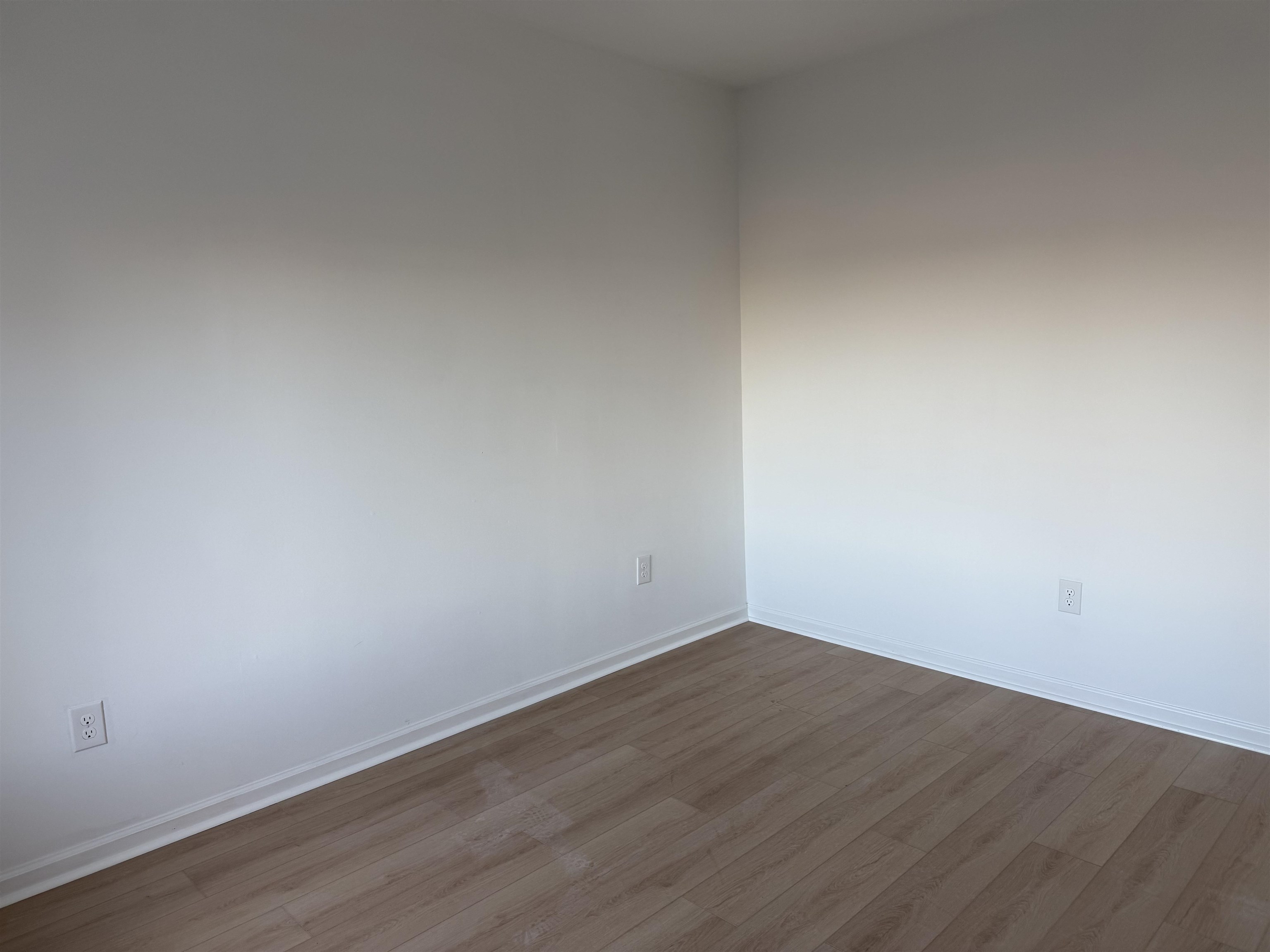 9007 Riverside Place, Unit 3 North Bergen, NJ 07047 - Photo 10 of 18 a view of an empty room with wooden floor