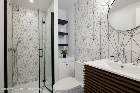 a bathroom with a sink toilet and shower