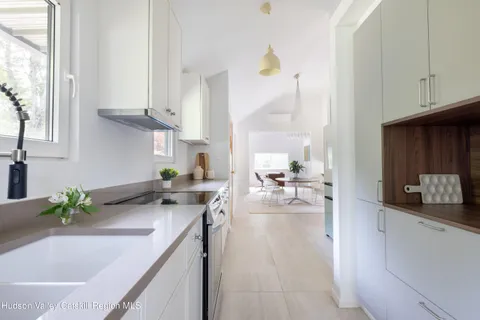 a kitchen with stainless steel appliances granite countertop a sink a stove and cabinets