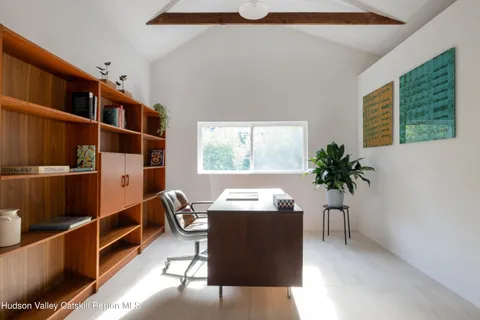 a living room with furniture windows and potted plants