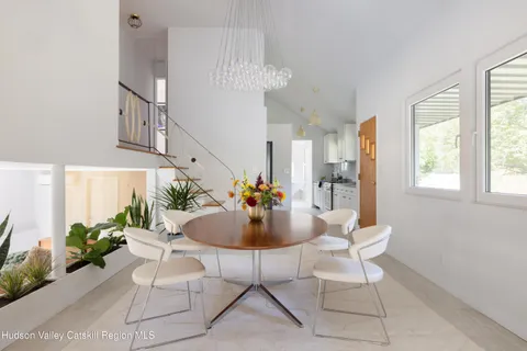 a dining room with furniture and a chandelier