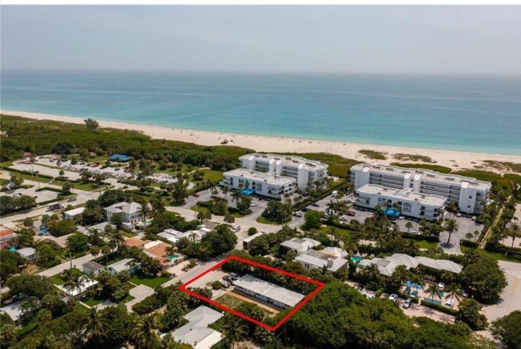 an aerial view of residential building and ocean