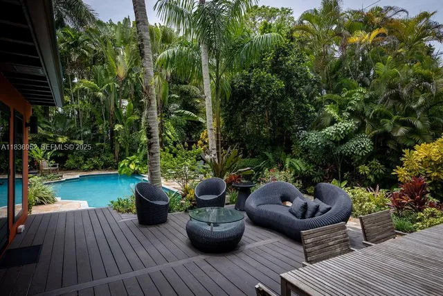 a view of a backyard with sitting area