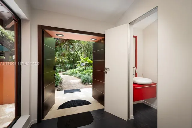 a living room with furniture a rug and a painting