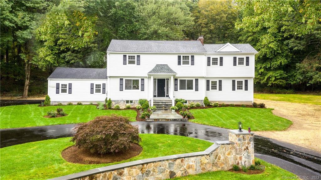 a front view of a house with garden and porch