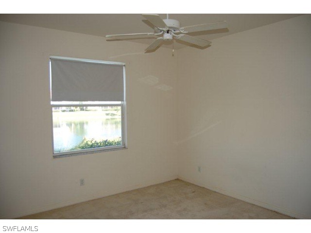 300 Robin Hood Circle, Unit 102 Naples, FL 34104 - Photo 4 of 8 a view of an empty room with a window