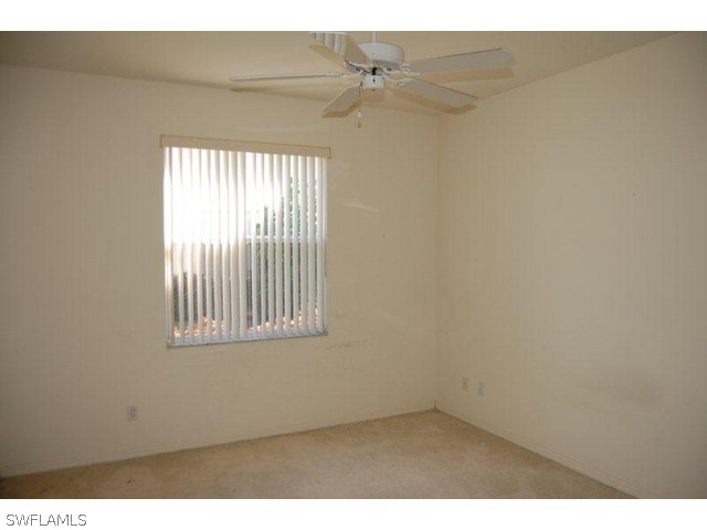 300 Robin Hood Circle, Unit 102 Naples, FL 34104 - Photo 5 of 8 a view of an empty room with a window