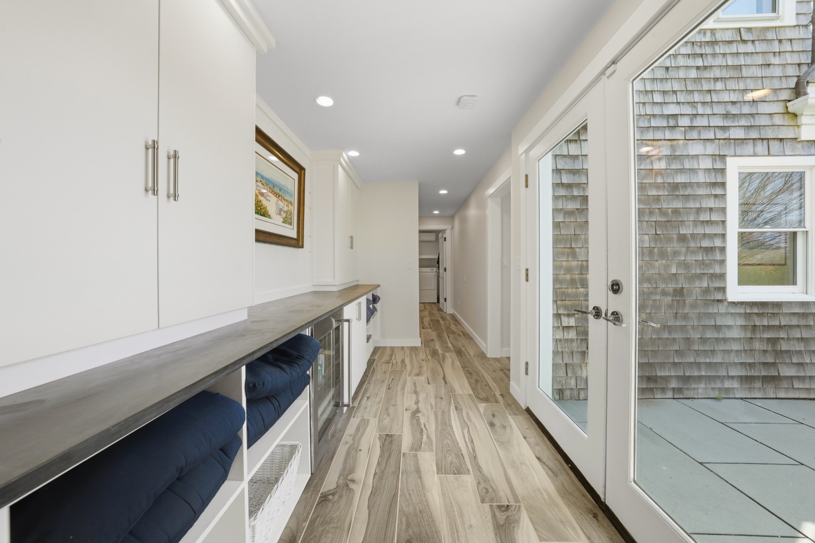 247 Polpis Road Nantucket, MA 02554 - Photo 26 of 52 a hallway with wooden floor and staircase
