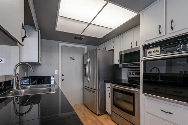 a view of a room with wooden floor