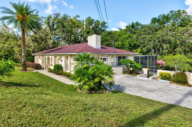 a view of a house with a yard and sitting area
