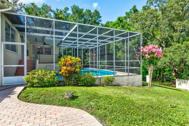 a view of a chair and table in back yard of a house