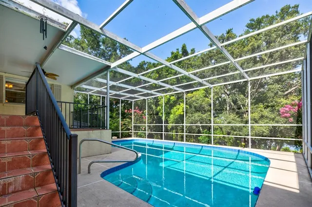 a view of a chair and table in the back yard of the house