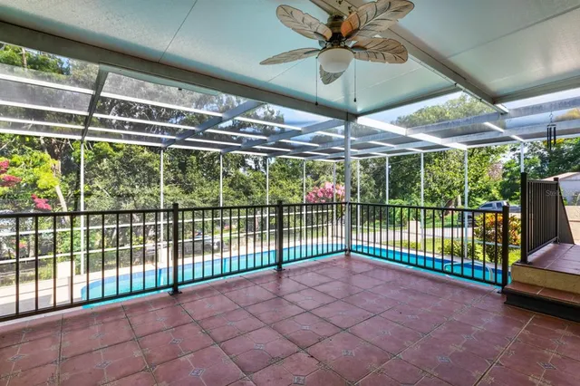a view of a hallway with wooden floor and a bathroom