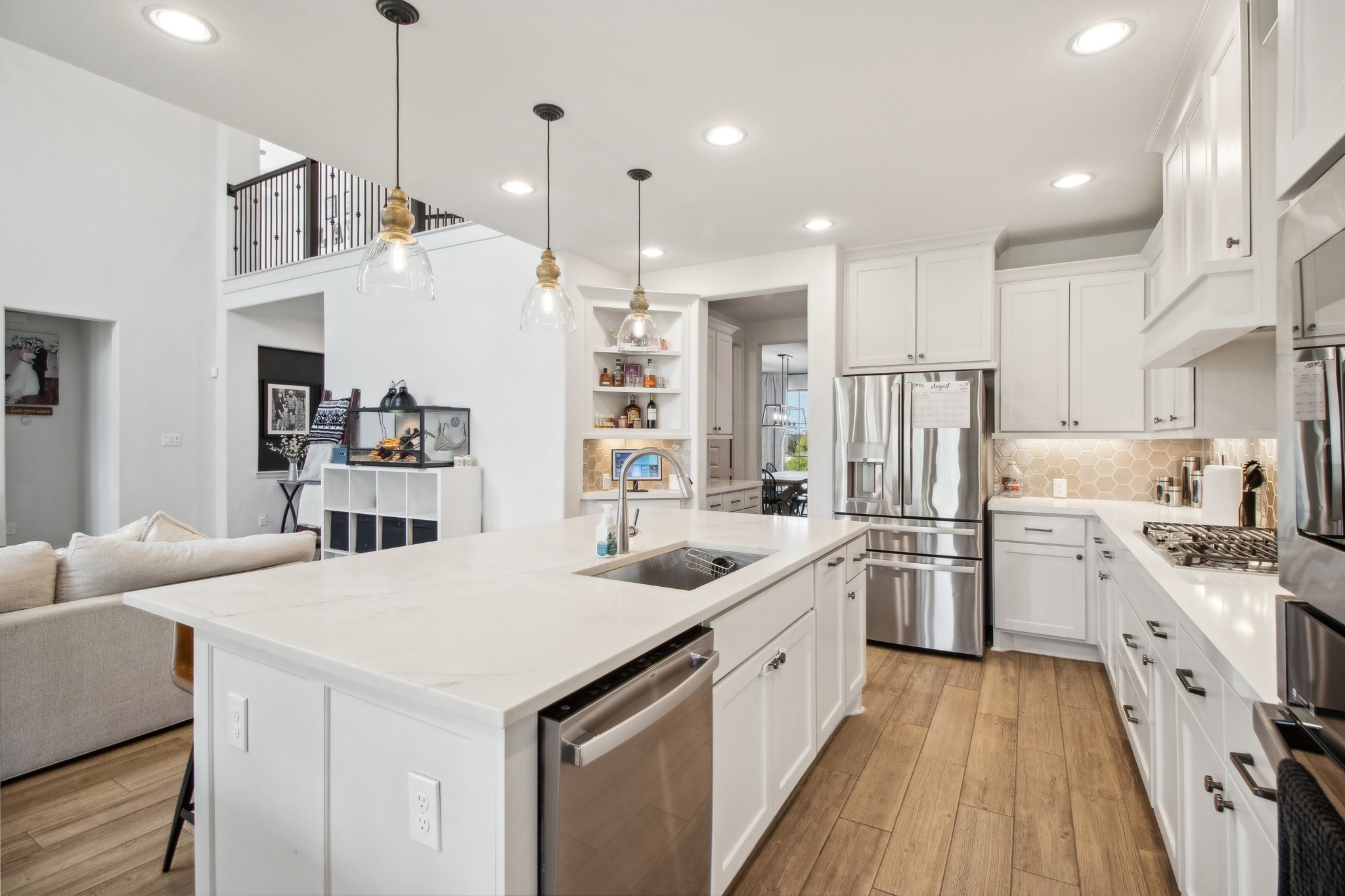 29819 Autumn Maple Court Fulshear, TX 77494 - Photo 12 of 47 a kitchen with white cabinets and stainless steel appliances