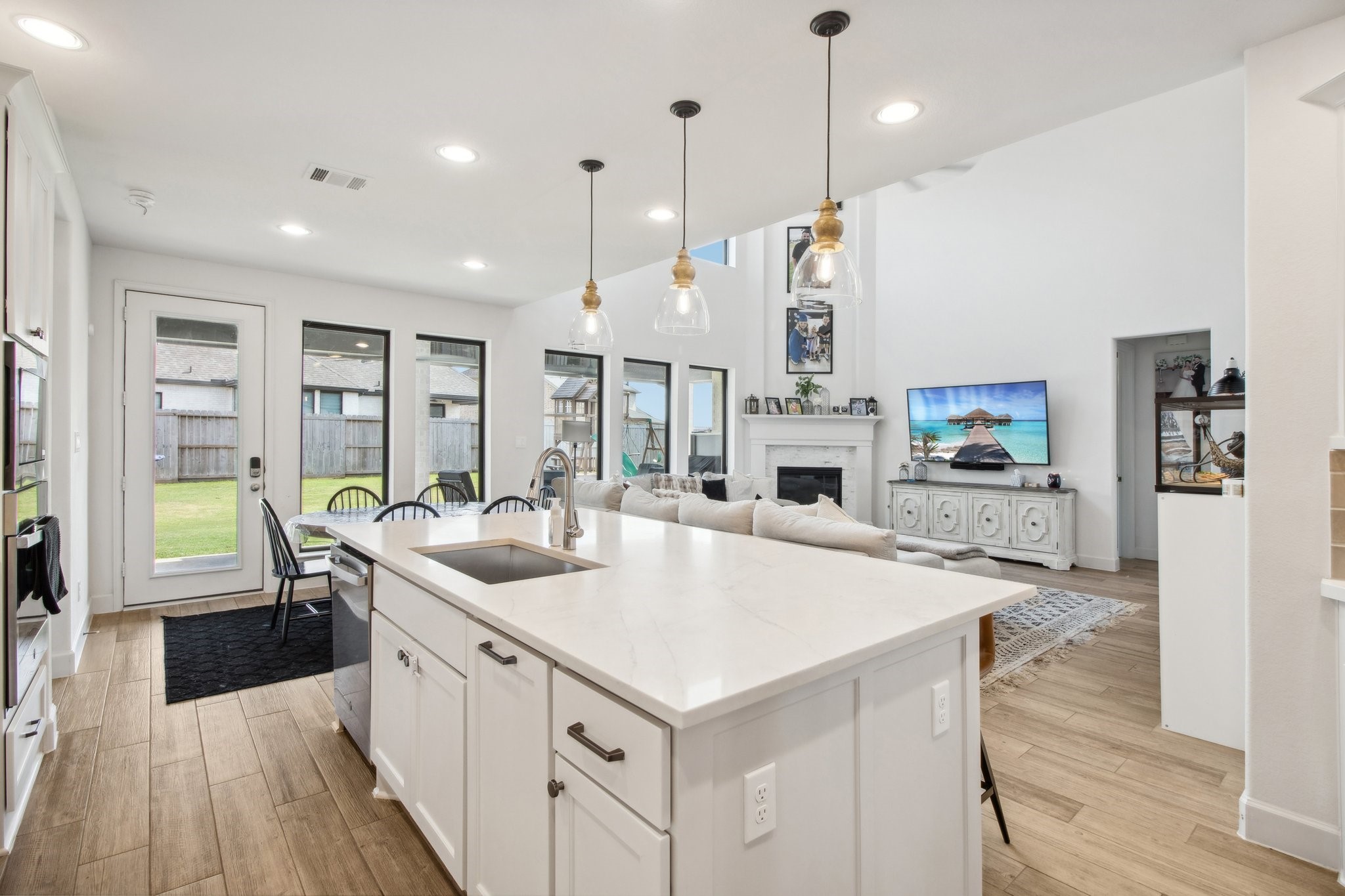 29819 Autumn Maple Court Fulshear, TX 77494 - Photo 13 of 47 a large kitchen with kitchen island a island a sink a stove and wooden floor