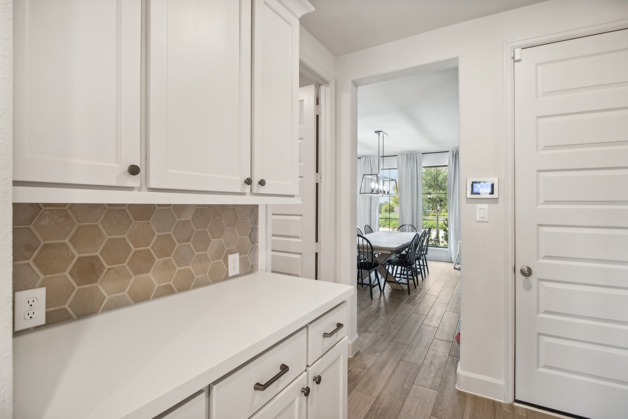 29819 Autumn Maple Court Fulshear, TX 77494 - Photo 24 of 47 a hallway with a white cabinets and wooden floor