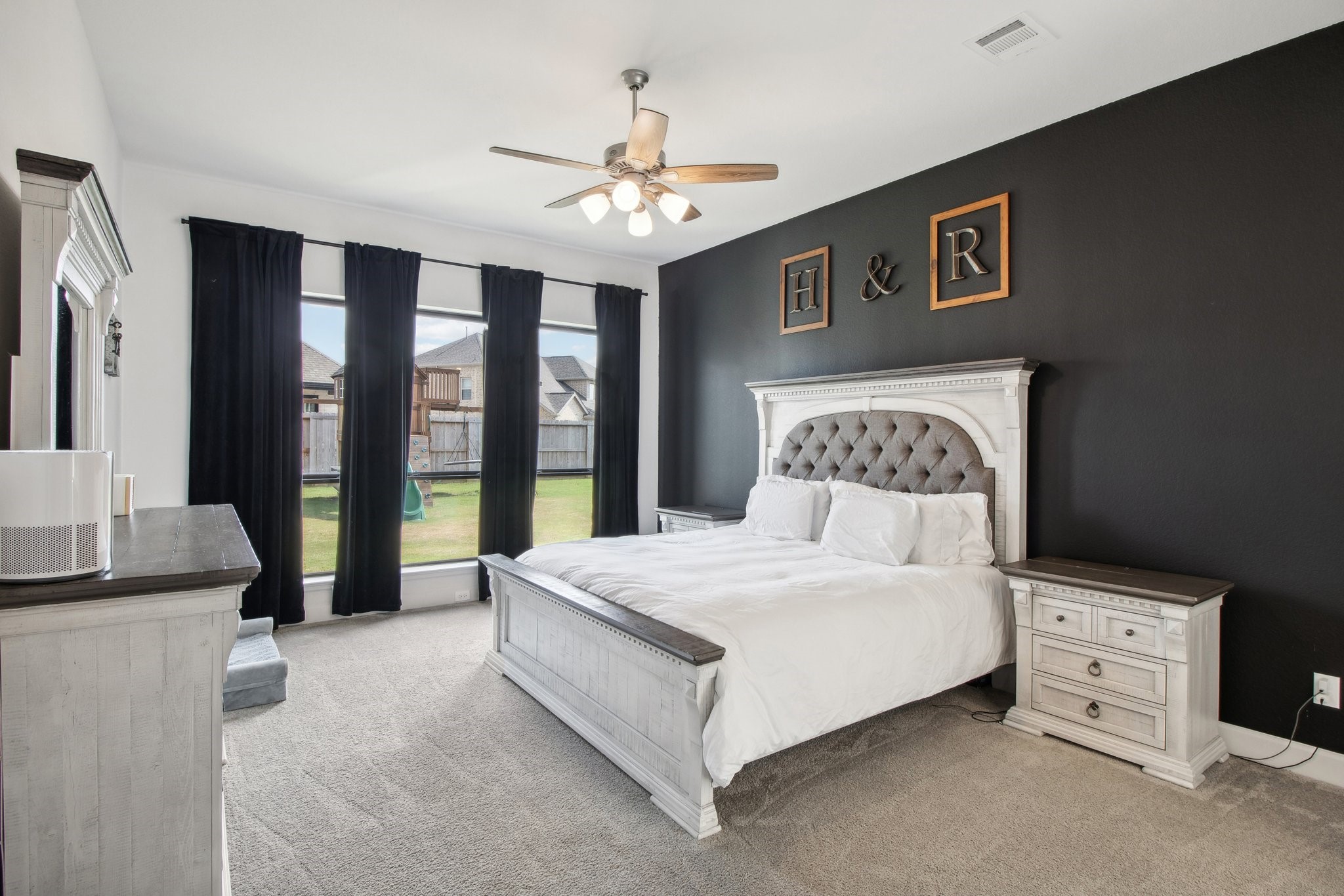 29819 Autumn Maple Court Fulshear, TX 77494 - Photo 26 of 47 a spacious bedroom with a large bed and a chandelier