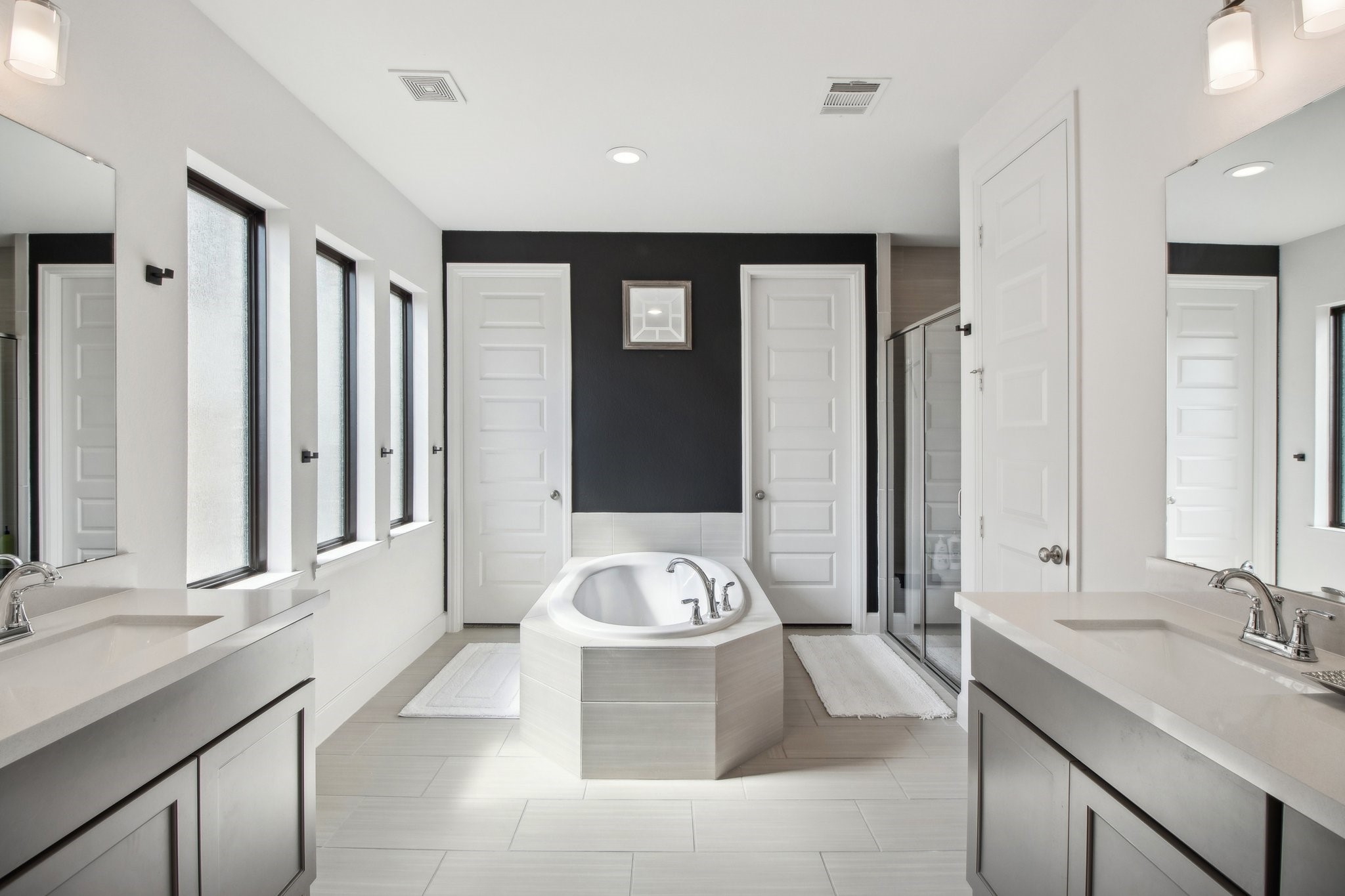 29819 Autumn Maple Court Fulshear, TX 77494 - Photo 28 of 47 a spacious bathroom with a double vanity sink tub and mirror