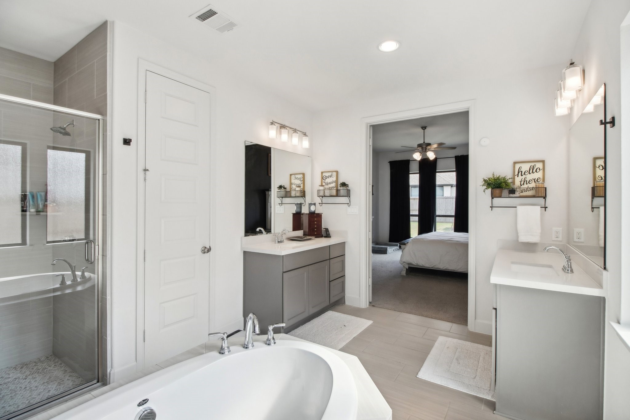 29819 Autumn Maple Court Fulshear, TX 77494 - Photo 29 of 47 a en suite spacious bathroom with a double vanity sink a mirror and a bathtub
