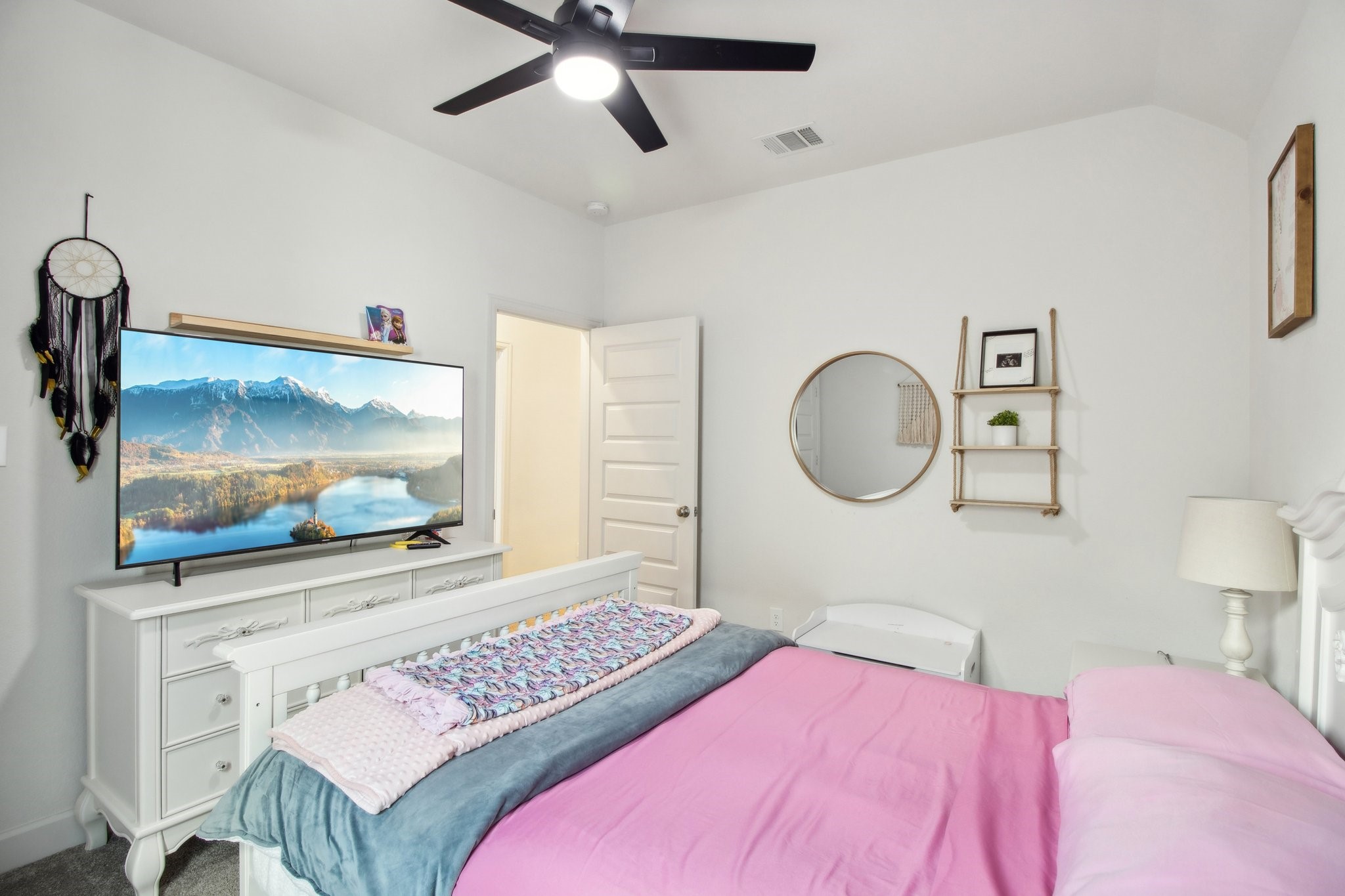 29819 Autumn Maple Court Fulshear, TX 77494 - Photo 40 of 47 a bedroom with a bed and a flat screen tv