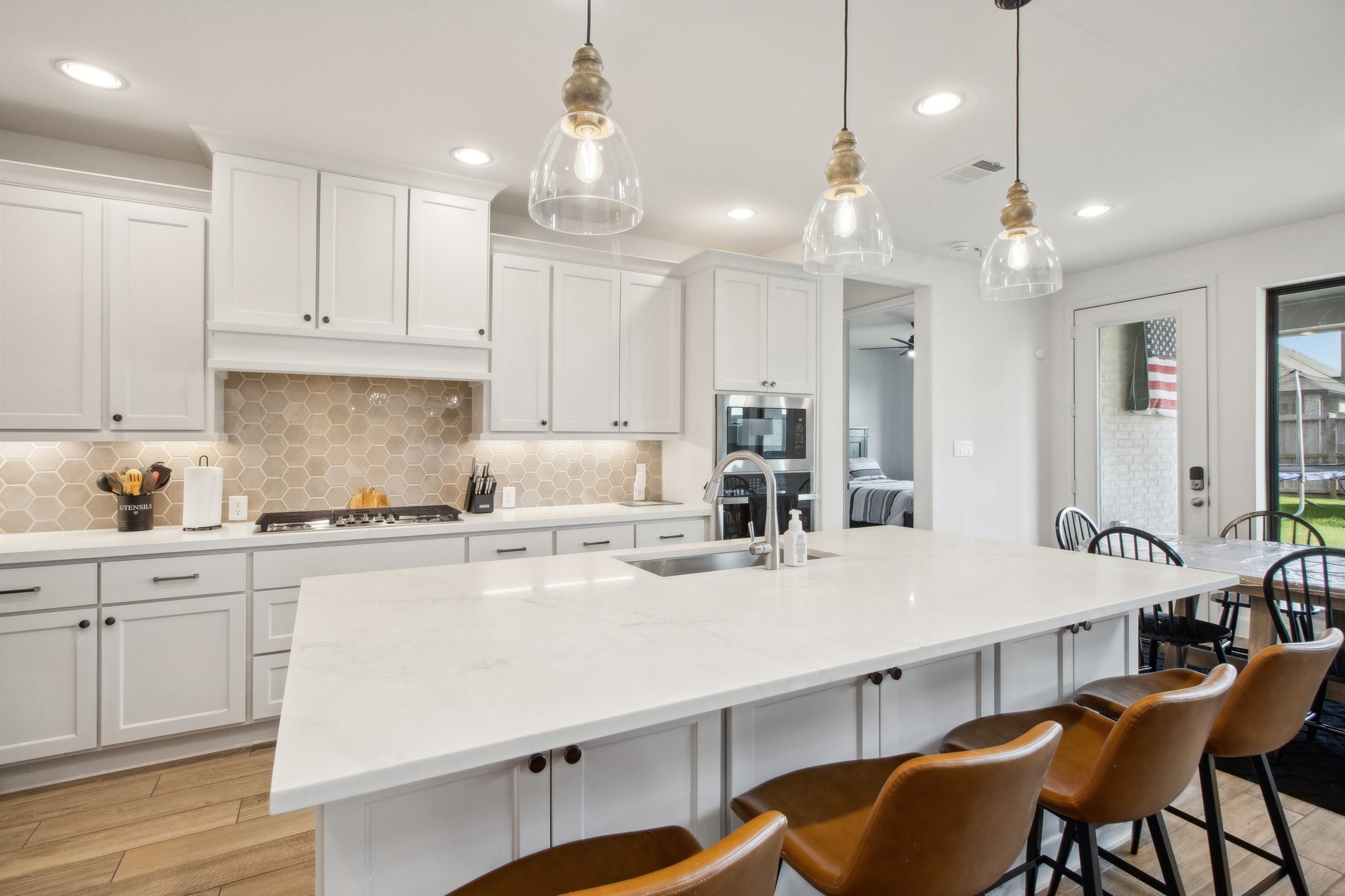 29819 Autumn Maple Court Fulshear, TX 77494 - Photo 10 of 47 a kitchen with a dining table chairs sink and cabinets
