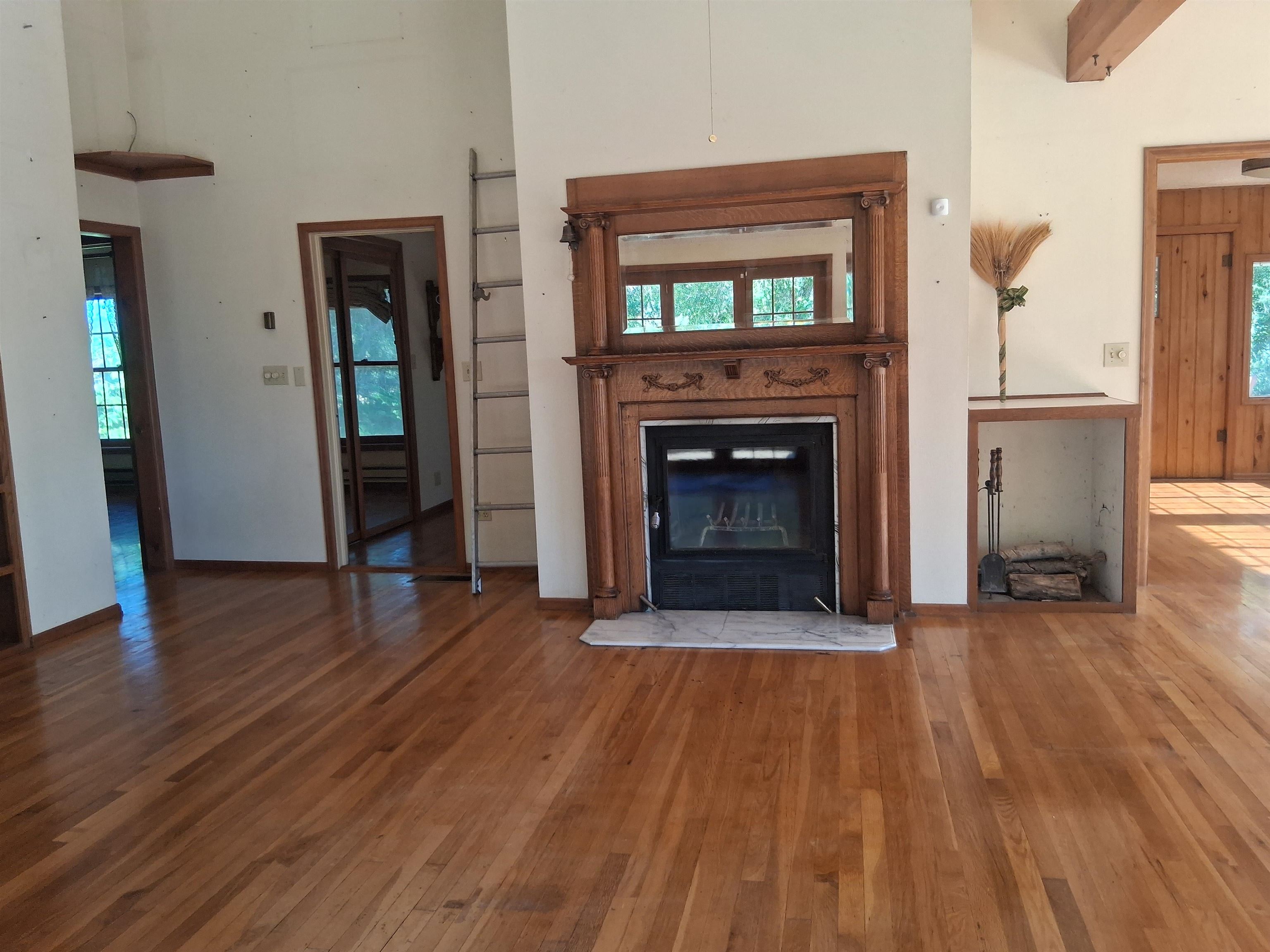 1983 River Road Fruita, CO 81521 - Photo 17 of 31 a view of an empty room with wooden floor fireplace and a window