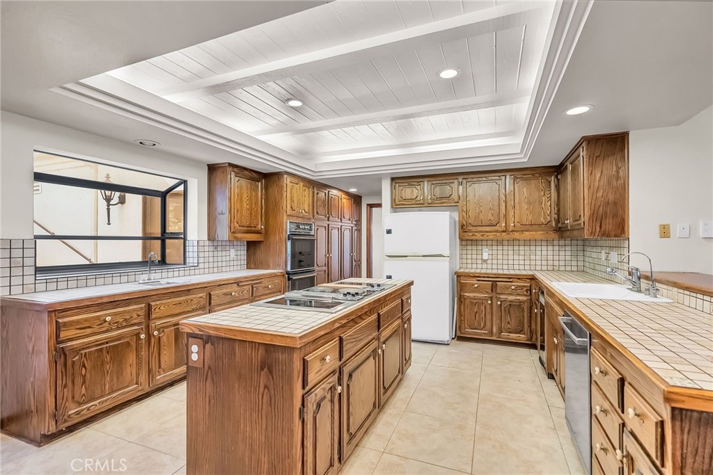 2572 Sunset Drive Riverside, CA 92506 - Photo 23 of 63 a kitchen with a stove sink and cabinets