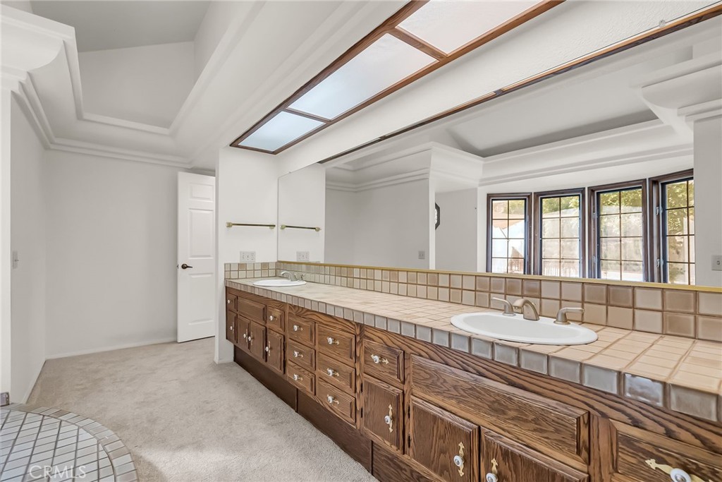 2572 Sunset Drive Riverside, CA 92506 - Photo 33 of 63 a spacious bathroom with a granite countertop double vanity sink a mirror and a bathtub