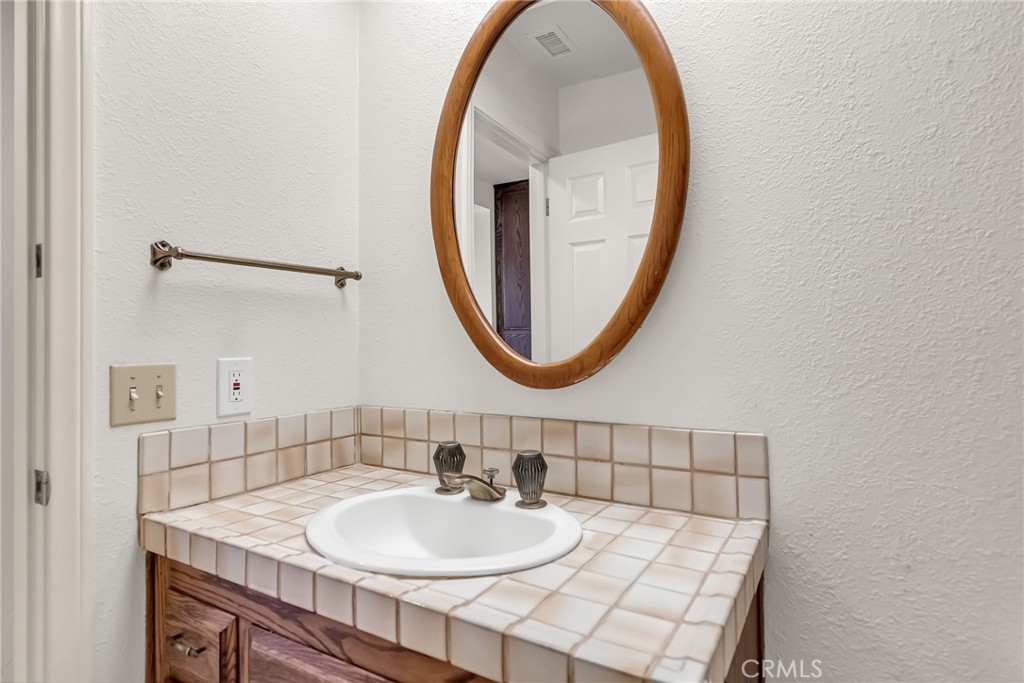 2572 Sunset Drive Riverside, CA 92506 - Photo 38 of 63 a bathroom with a sink and a mirror