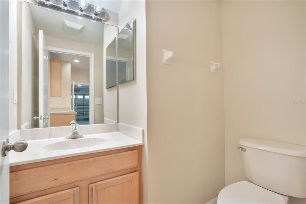 15031 Skip Jack Loop Lakewood Ranch, FL 34202 - Photo 26 of 27 a bathroom with a toilet sink and mirror