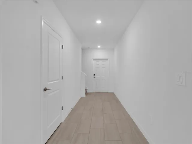 a view of a hallway with wooden floor