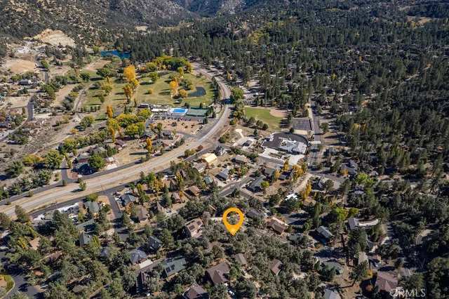 an aerial view of a houses with a yard