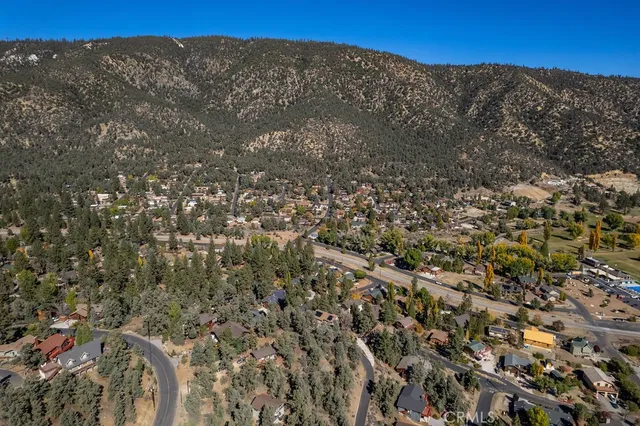 a view of a large building with mountains in the background