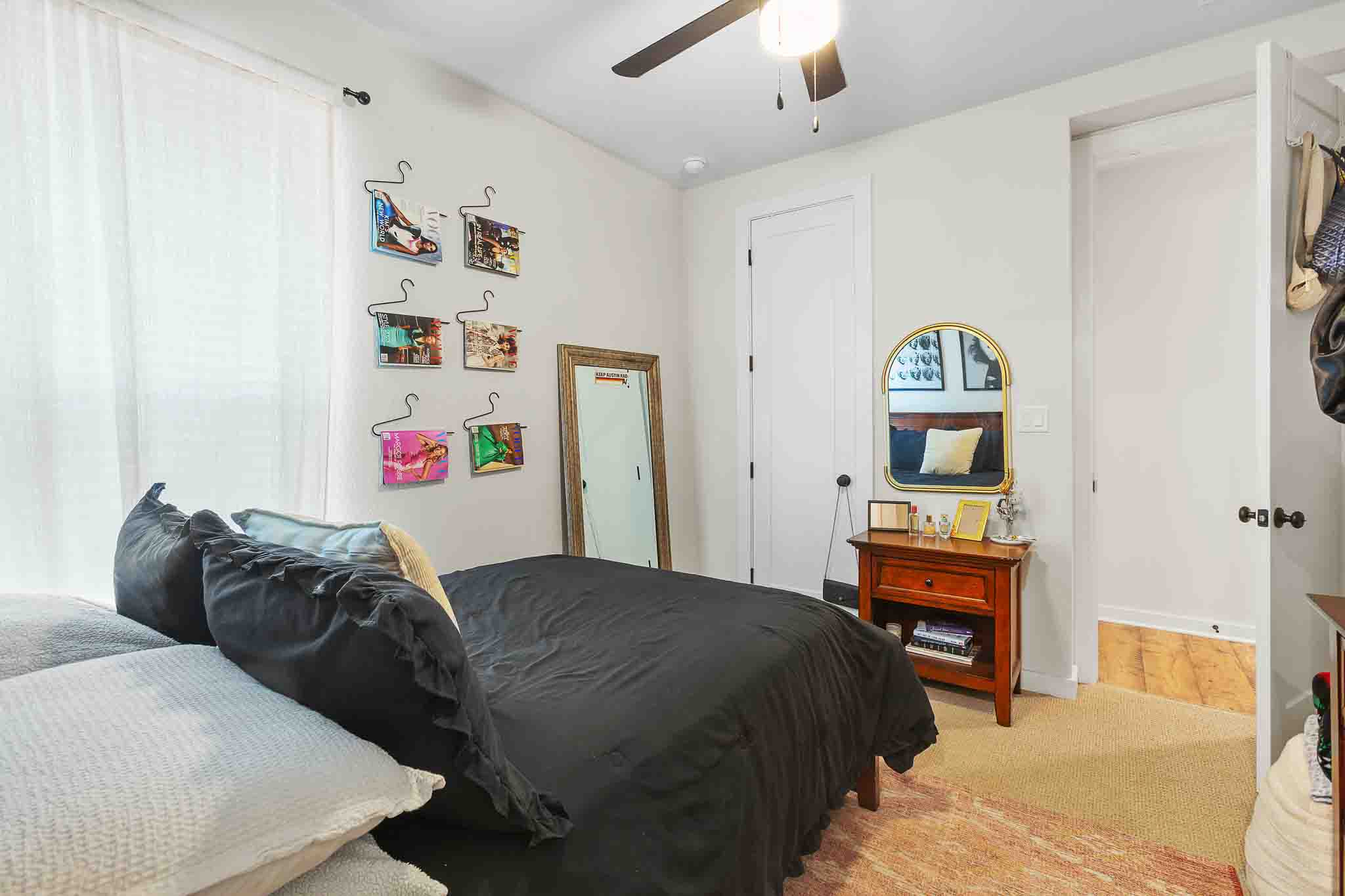 220 Basket Flower Loop Kyle, TX 78640 - Photo 22 of 40 Well-lit sleeping quarters with textured carpet and an overhead ceiling fan.