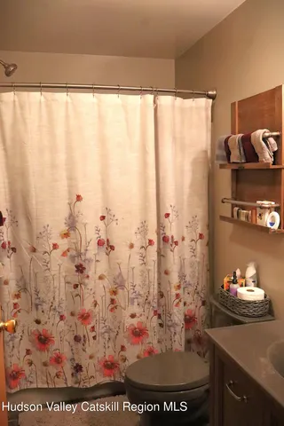 a view of a bathroom with window and tub